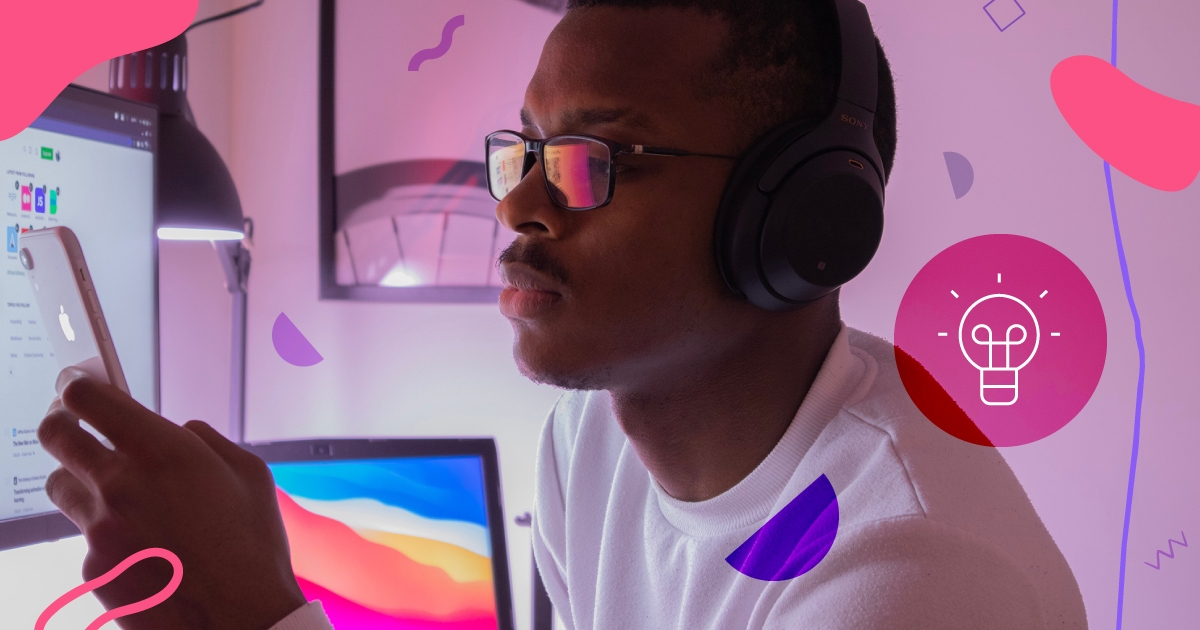 Young man looking at his phone in his office.